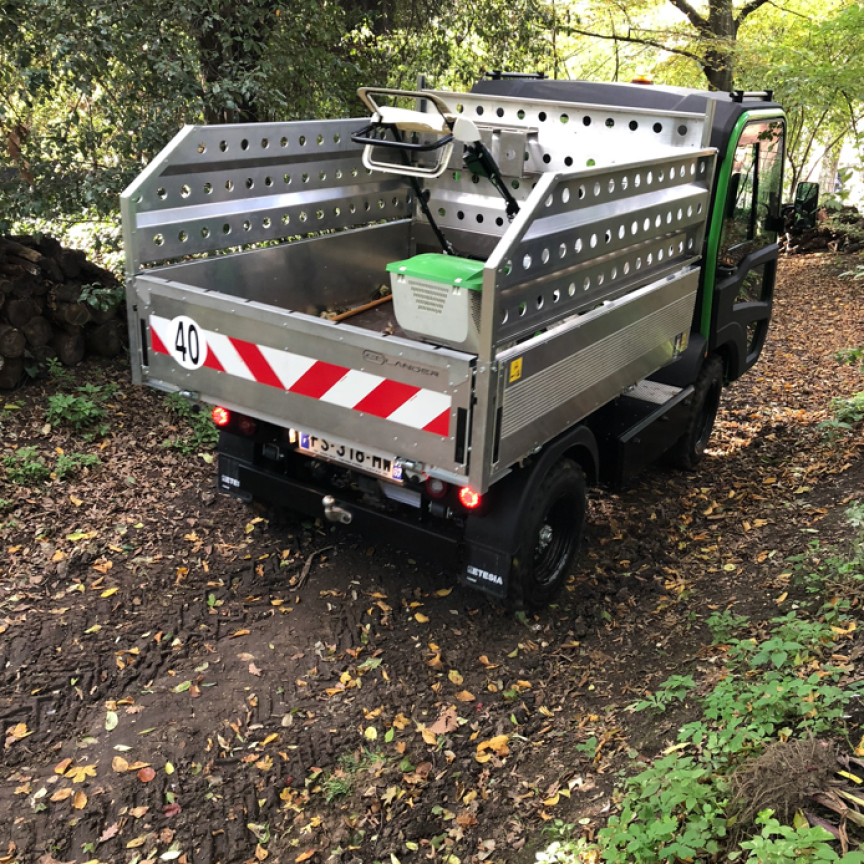 et lander with a long-body tipper in the forest