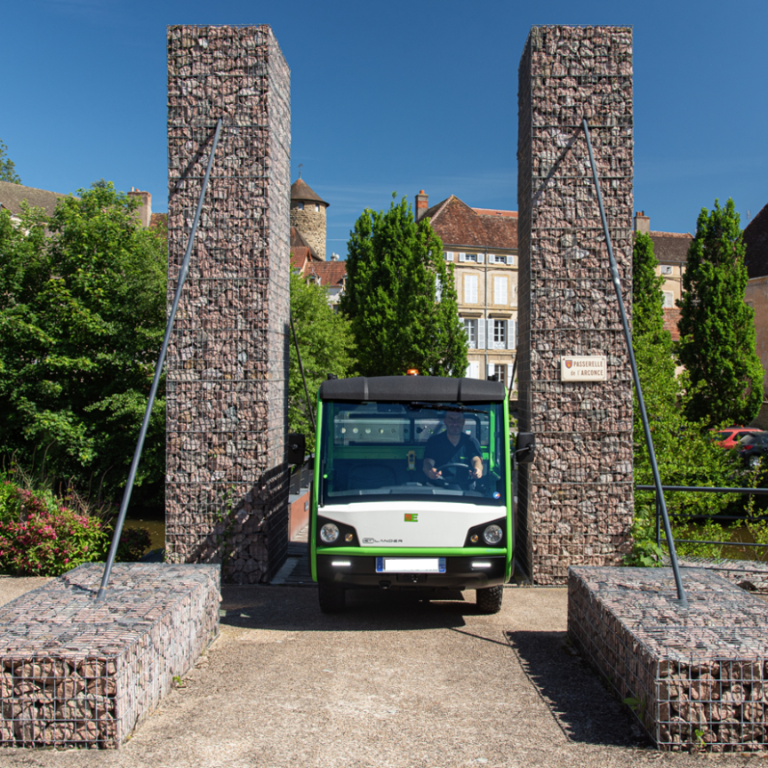 et lander coming out of a garden through a narrow gate